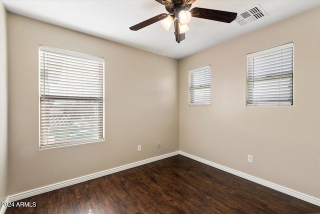 unfurnished room with ceiling fan and dark wood-type flooring