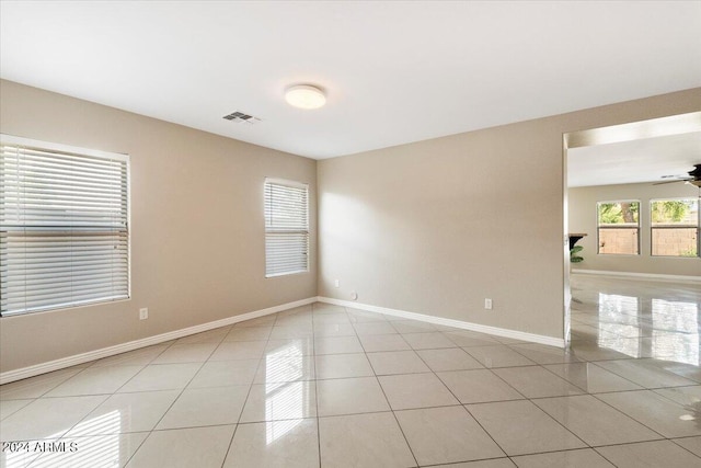 unfurnished room with ceiling fan and light tile patterned floors