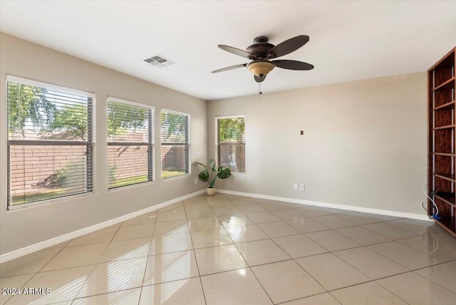 spare room featuring ceiling fan and light tile patterned flooring