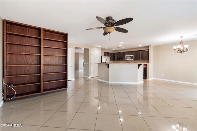 unfurnished living room featuring light tile patterned floors and ceiling fan with notable chandelier