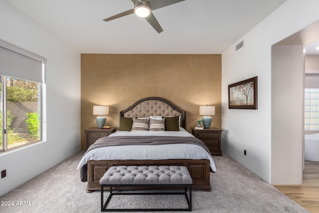 bedroom with light hardwood / wood-style floors and ceiling fan