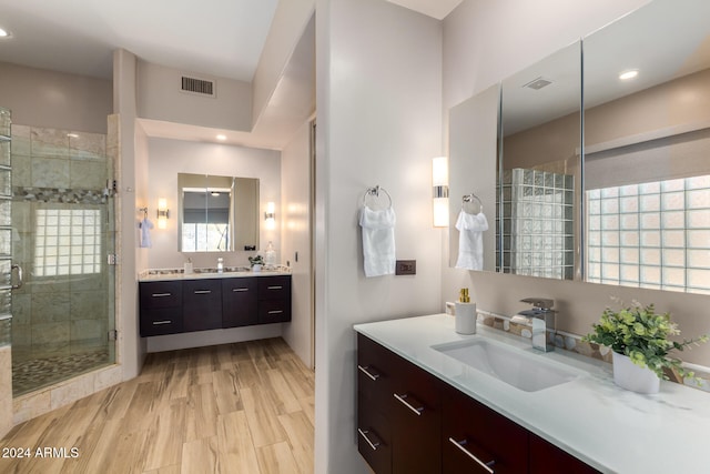 bathroom featuring hardwood / wood-style floors, vanity, and an enclosed shower