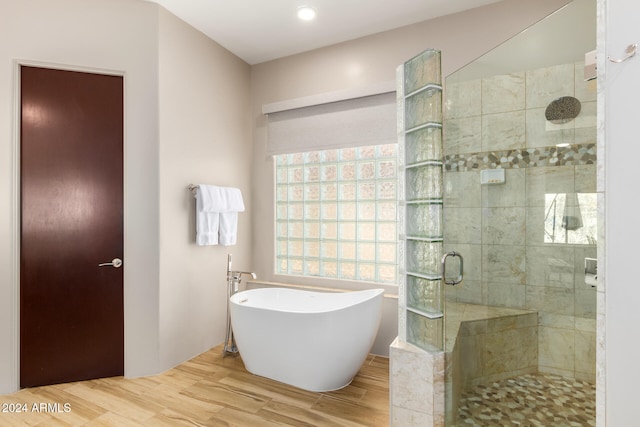 bathroom with hardwood / wood-style flooring and plus walk in shower