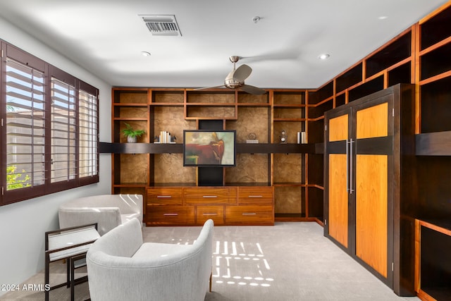 office area with light carpet and built in shelves