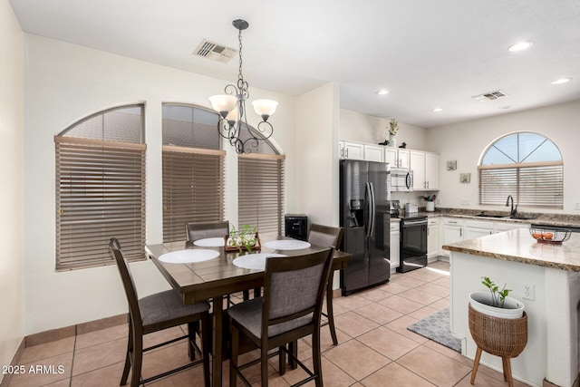 6505 S 15th Dr, Phoenix, AZ 85041 - dining space with a chandelier, light tile patterned floors, and recessed lighting