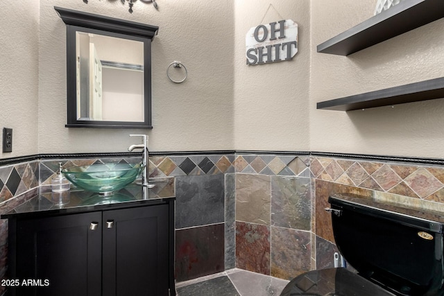 6505 S 15th Dr, Phoenix, AZ 85041 - bathroom featuring tile walls, toilet, and vanity