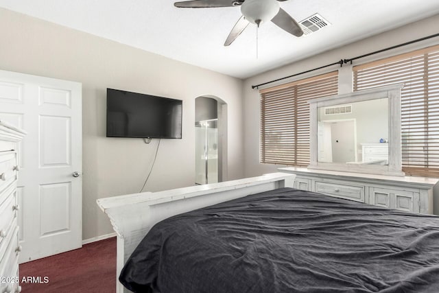 6505 S 15th Dr, Phoenix, AZ 85041 - bedroom with dark colored carpet, multiple windows, a ceiling fan, and ensuite bath