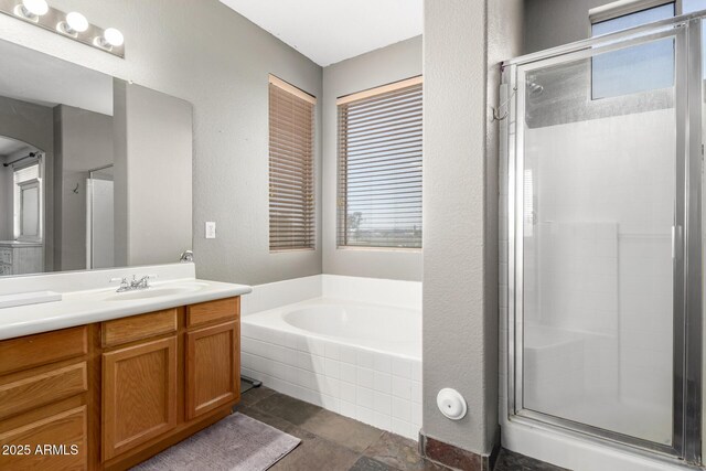 6505 S 15th Dr, Phoenix, AZ 85041 - full bathroom featuring a stall shower, a bath, vanity, and a textured wall
