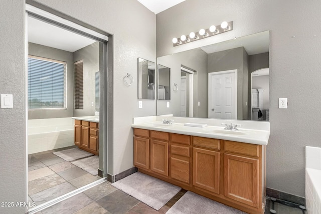 6505 S 15th Dr, Phoenix, AZ 85041 - full bath with double vanity, a bath, and a textured wall