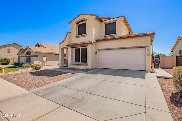 6505 S 15th Dr, Phoenix, AZ 85041 - mediterranean / spanish house featuring stucco siding, driveway, a tile roof, fence, and a garage