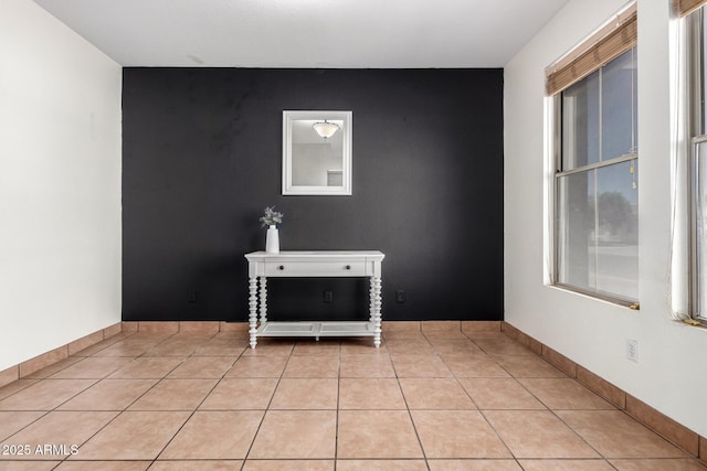 6505 S 15th Dr, Phoenix, AZ 85041 - unfurnished room featuring an accent wall and light tile patterned flooring