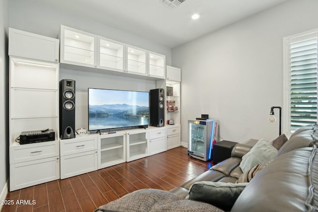 living area featuring recessed lighting, visible vents, and wood finish floors