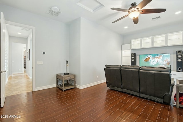 living area with ceiling fan, baseboards, visible vents, and dark wood finished floors