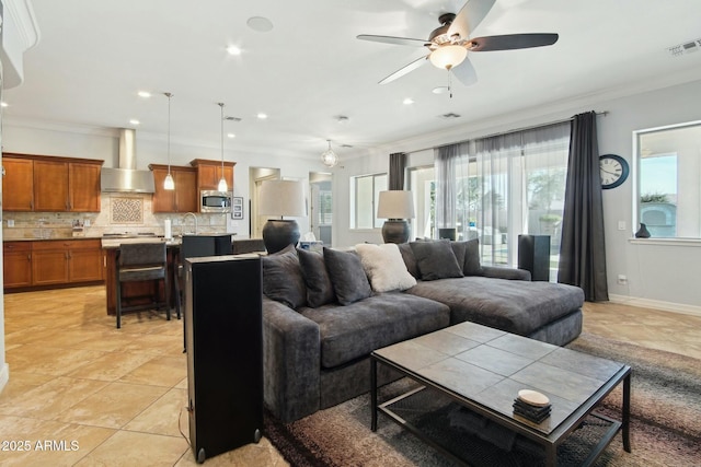 living room featuring crown molding, recessed lighting, visible vents, a ceiling fan, and baseboards