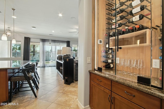 wine cellar featuring ornamental molding, recessed lighting, and light tile patterned floors