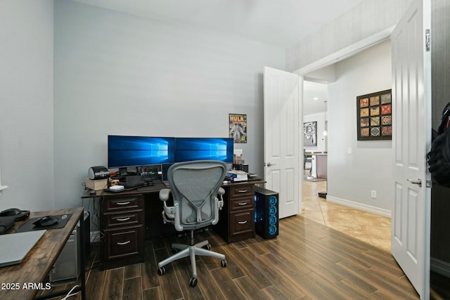 home office with baseboards and wood finished floors