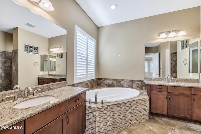 full bath with a garden tub, two vanities, a sink, and visible vents