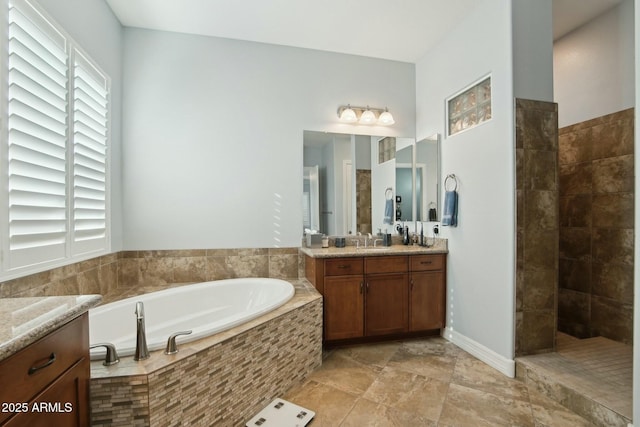 bathroom featuring vanity and a bath