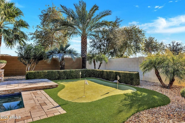 view of yard with a fenced backyard and a swimming pool