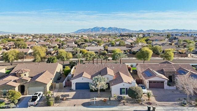 drone / aerial view featuring a residential view and a mountain view