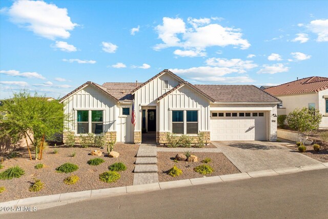 21391 W Mariposa St, Buckeye, AZ 85396 - modern farmhouse style home featuring board and batten siding, an attached garage, driveway, and stone siding