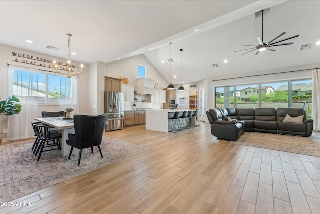 21391 W Mariposa St, Buckeye, AZ 85396 - dining area with a chandelier, high vaulted ceiling, light wood-type flooring, ceiling fan, and recessed lighting