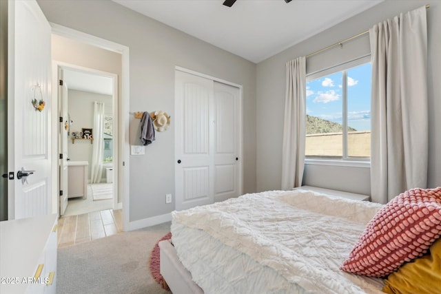 21391 W Mariposa St, Buckeye, AZ 85396 - bedroom with light carpet, a closet, baseboards, and a ceiling fan