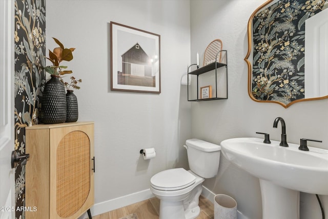 21391 W Mariposa St, Buckeye, AZ 85396 - bathroom with wood finished floors, toilet, baseboards, and a sink