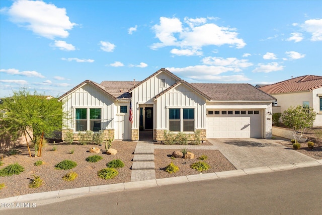 21391 W Mariposa St, Buckeye, AZ 85396 - modern inspired farmhouse featuring board and batten siding, an attached garage, driveway, and stone siding