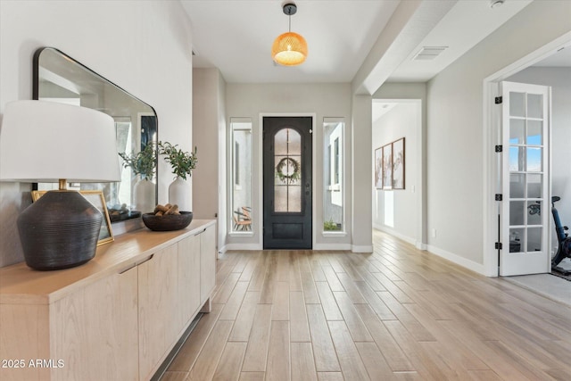 21391 W Mariposa St, Buckeye, AZ 85396 - foyer entrance featuring light wood-type flooring and baseboards