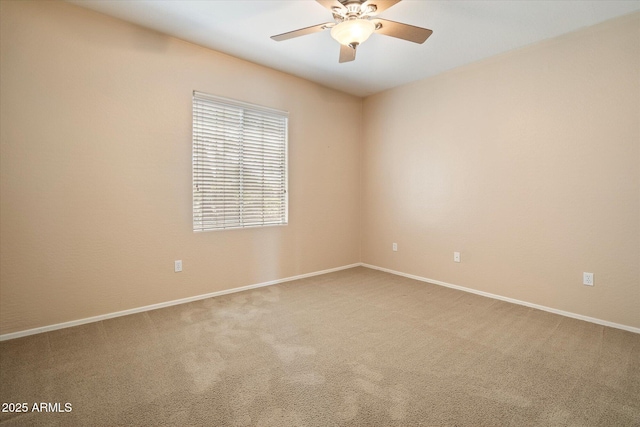 unfurnished room with a ceiling fan, carpet floors, and baseboards