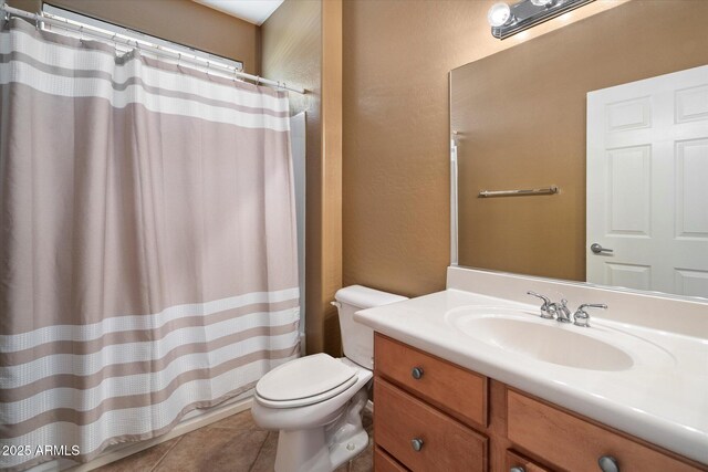 bathroom featuring a textured wall, a shower with shower curtain, toilet, tile patterned floors, and vanity