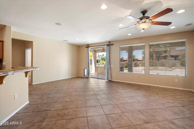 unfurnished living room featuring light tile patterned flooring, a ceiling fan, recessed lighting, and baseboards