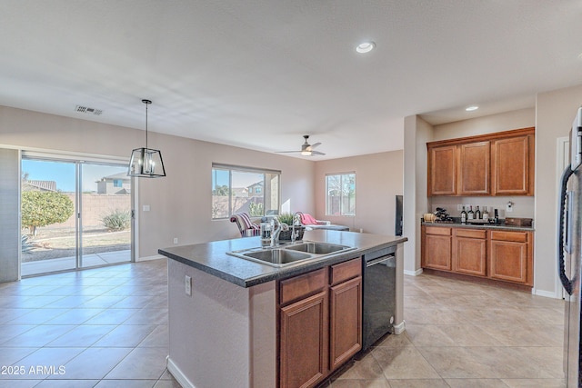 kitchen featuring sink, dishwasher, a center island with sink, light tile patterned flooring, and decorative light fixtures