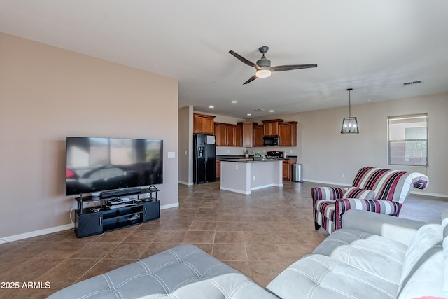 tiled living room with ceiling fan