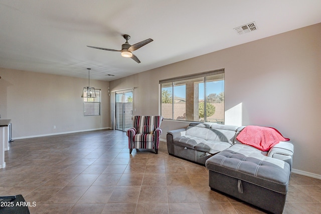 tiled living room with ceiling fan