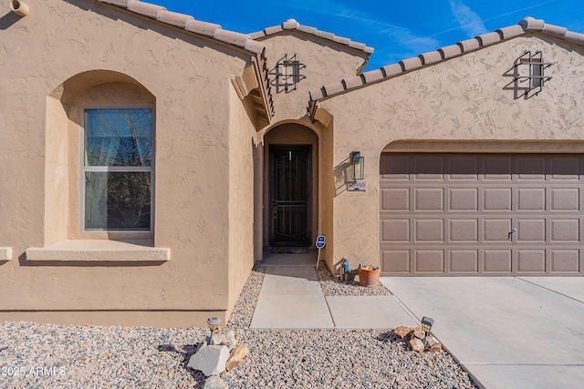 view of exterior entry with a garage