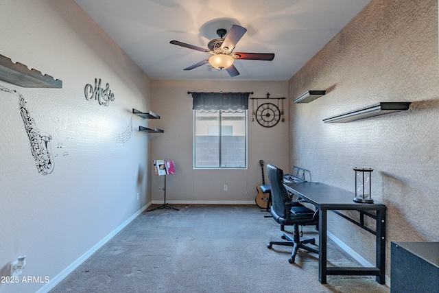 carpeted office space featuring ceiling fan