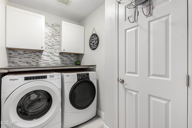washroom featuring cabinet space, separate washer and dryer, baseboards, and visible vents