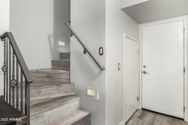 stairway with wood finished floors
