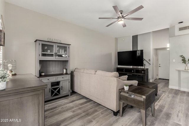living area with ceiling fan, light wood-style flooring, and visible vents