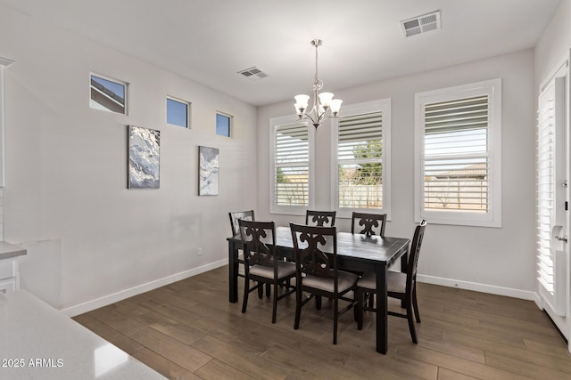 dining room featuring an inviting chandelier, dark wood-style floors, and visible vents