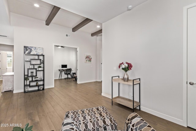 corridor with visible vents, wood finished floors, beam ceiling, and baseboards