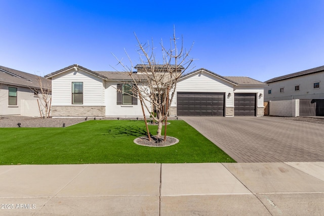 ranch-style home with a garage, a front lawn, decorative driveway, and brick siding