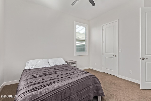 carpeted bedroom with ceiling fan and baseboards