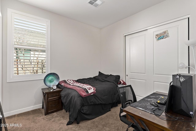 bedroom with carpet, a closet, visible vents, and baseboards