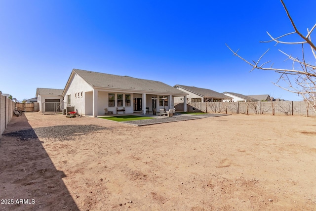 back of property with a patio area, a fenced backyard, and stucco siding