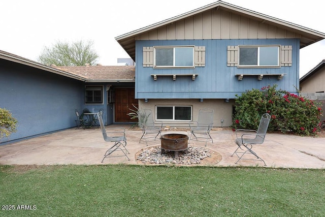 back of house featuring a patio area, stucco siding, an outdoor fire pit, and a yard