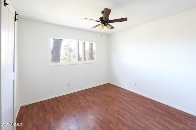 empty room featuring baseboards, a ceiling fan, and wood finished floors