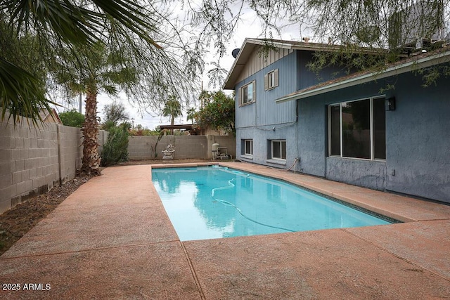 view of swimming pool featuring a fenced in pool, a patio, and a fenced backyard